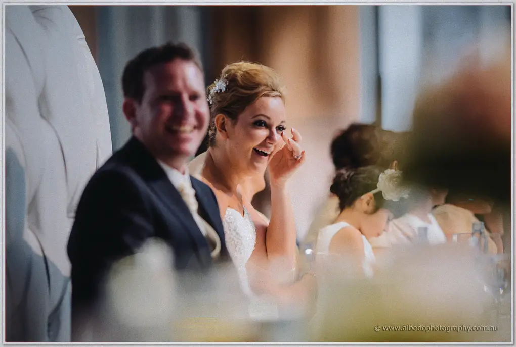 Kristina wipes away happy tears as Ashley laughs beside her during the speeches