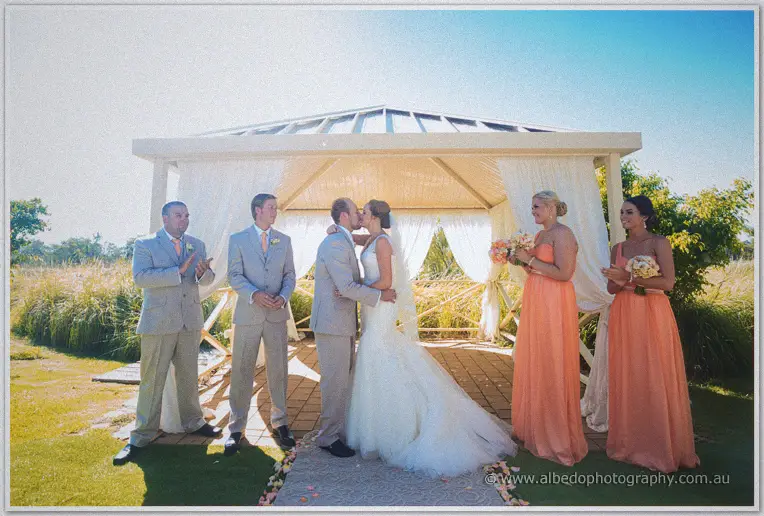 Katelyn and Matt share their first kiss as the bridal party applauds