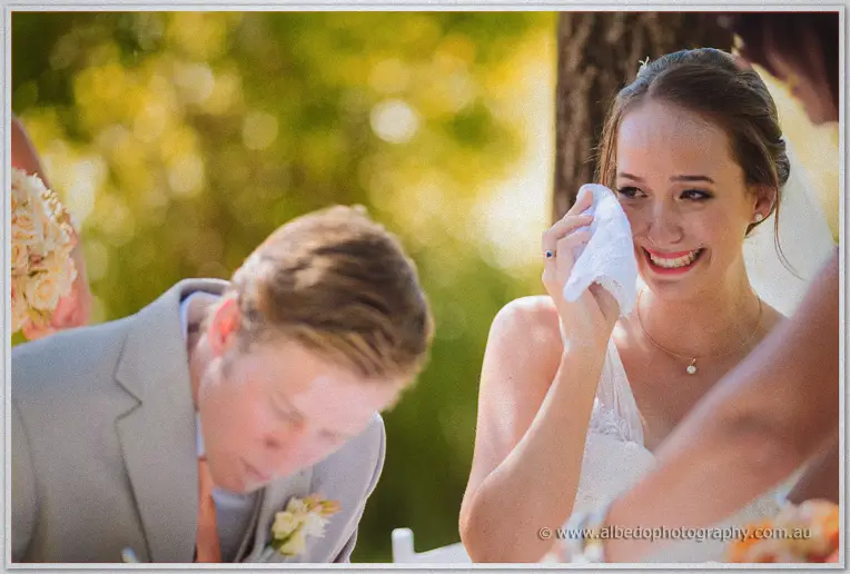 Katelyn laughs through tears as the marriage certificate is signed