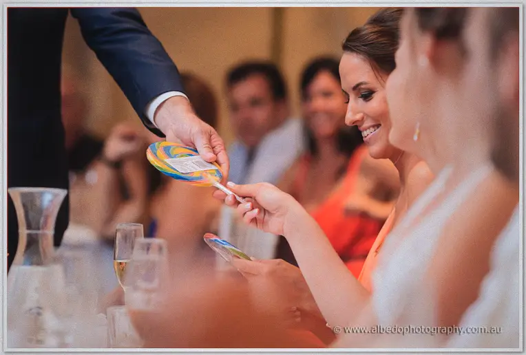Diptych pairing the Matthew and Katelyn menu card with the couple laughing at their welcome table