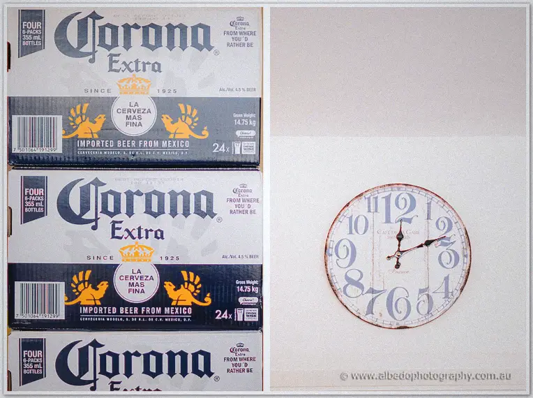 Stacked beer cartons beside a round wall clock ticking on the wall before the ceremony
