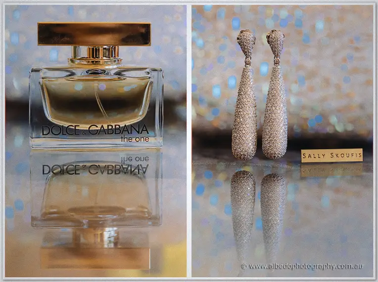 Gold-capped perfume bottle and sparkling teardrop earrings glinting on a sequinned tabletop
