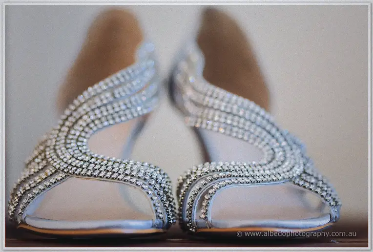 Teigan's silver sandals gleam with rows of sparkling diamantes in soft morning light