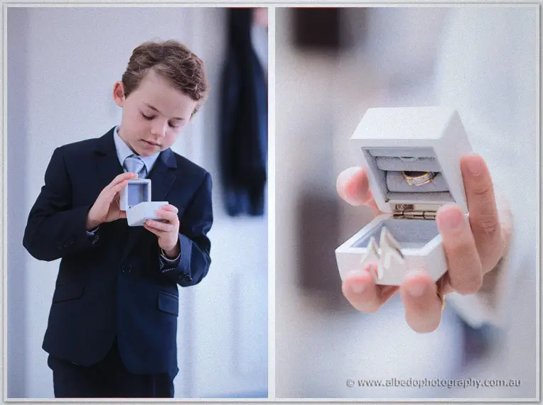 The page boy opens a ring box as a groomsman holds the wedding bands toward the camera.