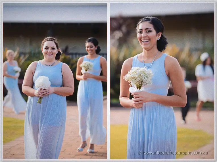 Two-panel procession of smiling bridesmaids in pale blue gowns carrying white posies down the brick pathway