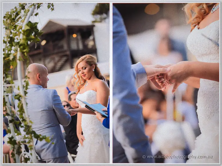 Close-up of Michael sliding the wedding ring onto Jasmine's finger during the ceremony.