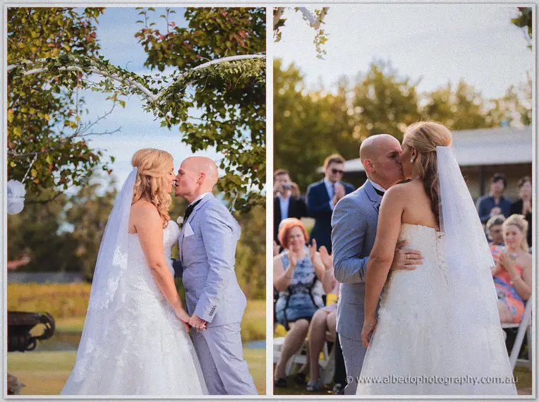 Jasmine and Michael share their first kiss under the leafy arbour as guests applaud.
