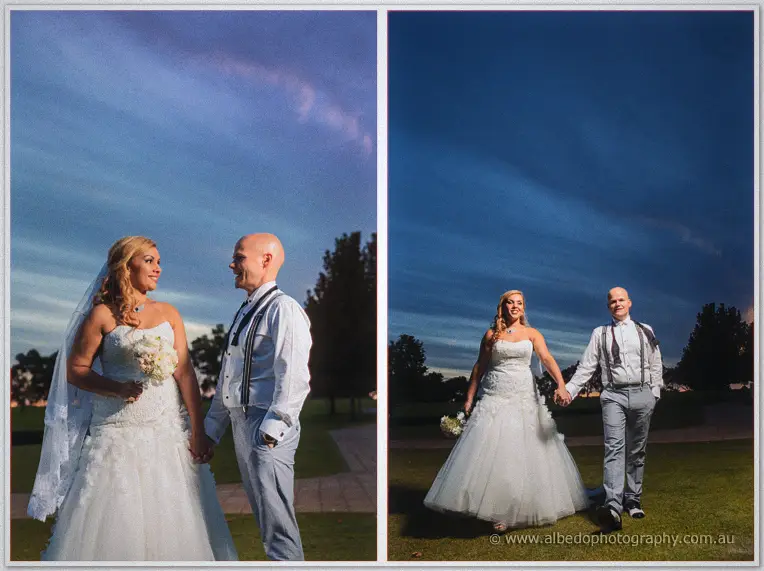 Jasmine and Michael walk hand in hand across the lawn beneath deep blue evening clouds.