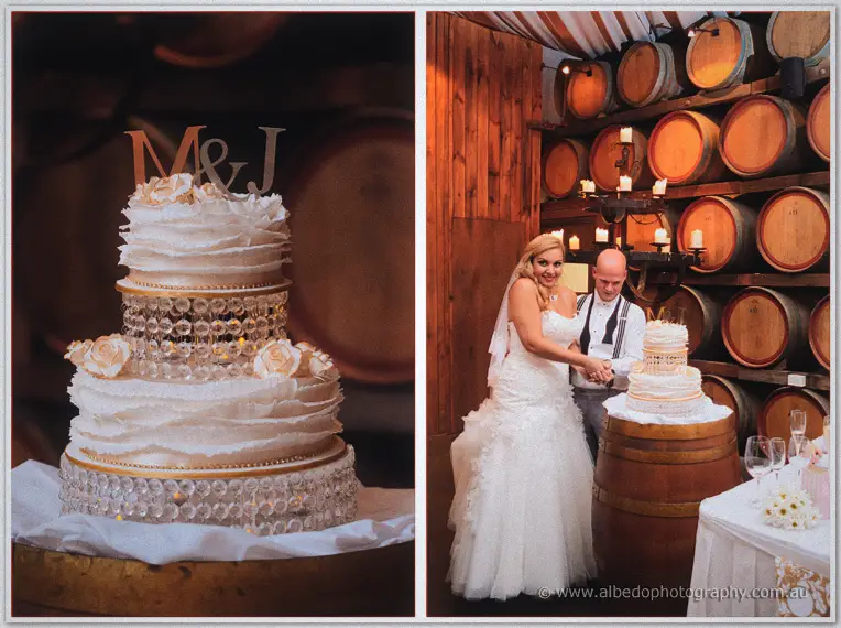 Jasmine and Michael cut their crystal-banded cake beside a glowing candelabra in the Sandalford barrel room.