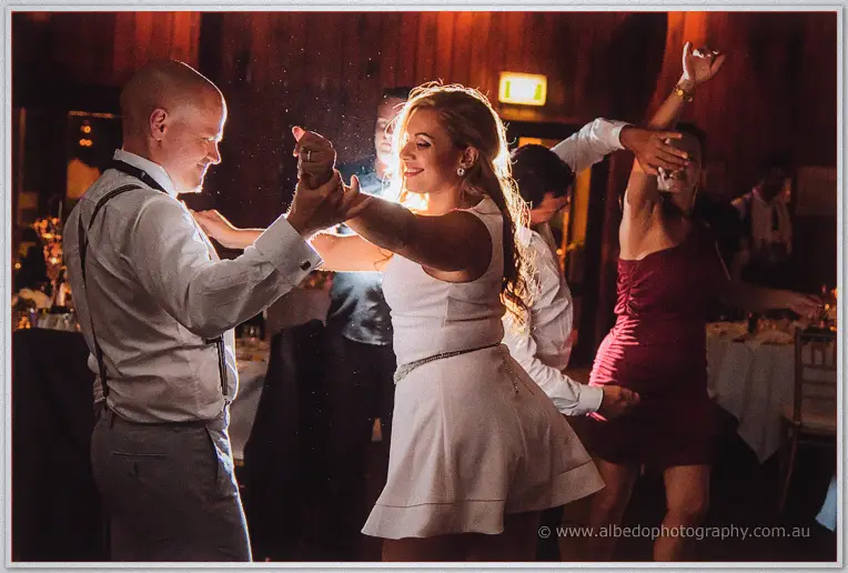 Jasmine twirls with suspended guests around her, dancing shoulder to shoulder in the packed hall.