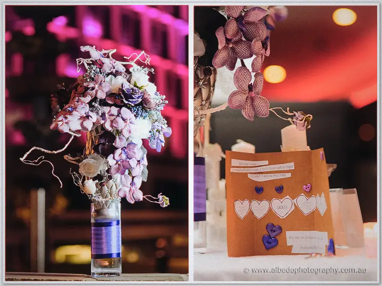 Purple orchid centerpiece beside a handmade card of button hearts spelling GOLD on Loan and Alex's table.