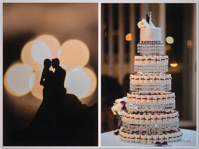 Diorama of a silhouetted couple kissing against warm bokeh beside their crystal-strung tiered cake