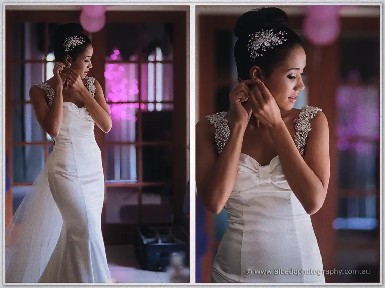 Cristal fastens a diamond earring in twin portraits, cherry blossoms glowing pink behind her