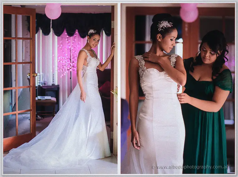 Cristal shows off her full train by the doorway as a bridesmaid adjusts her lace straps