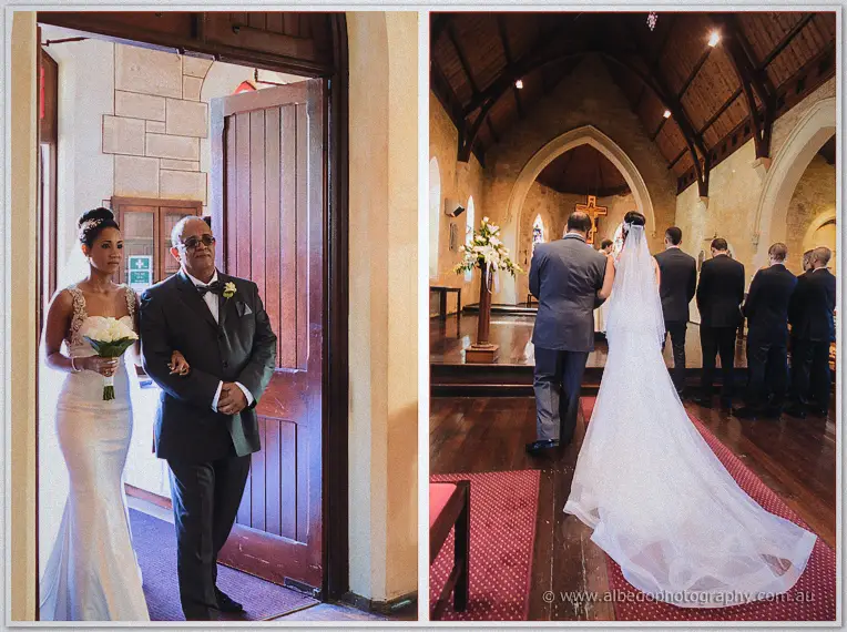 Bride and her father arrive at the stone church doorway before she walks the aisle past standing guests.