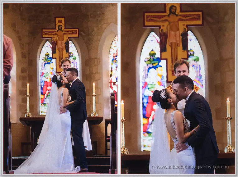 Cristal and Troy share their first kiss at the altar, veil trailing, crucifix and stained glass behind them.