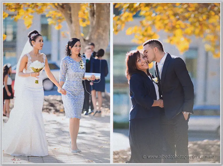 Bride walking hand in hand with her mother in a blue lace dress, then the groom kissing his mother's cheek.