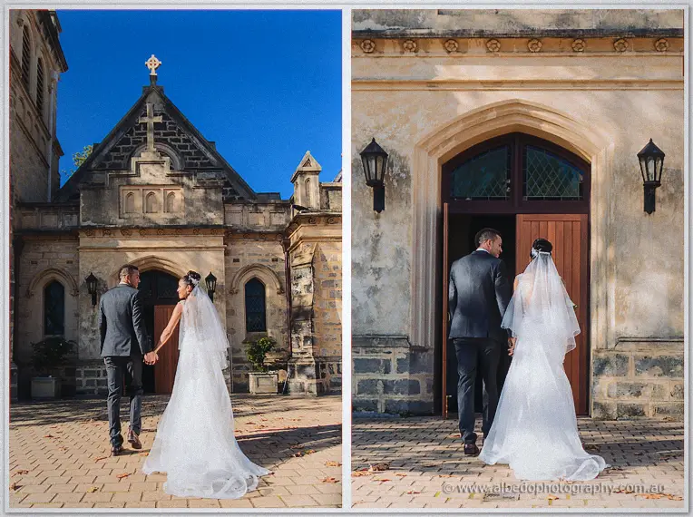 The newlyweds embrace below the stone bell tower, then kiss by the church's timber doors in bright sun.