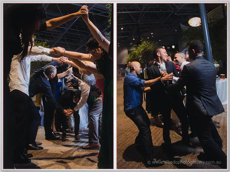 Guests form a laughing tunnel of linked hands as Troy dances through with his friends