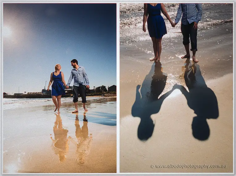 Twin frames of the couple on wet sand, one wide beneath the sun and one of their clasped shadows