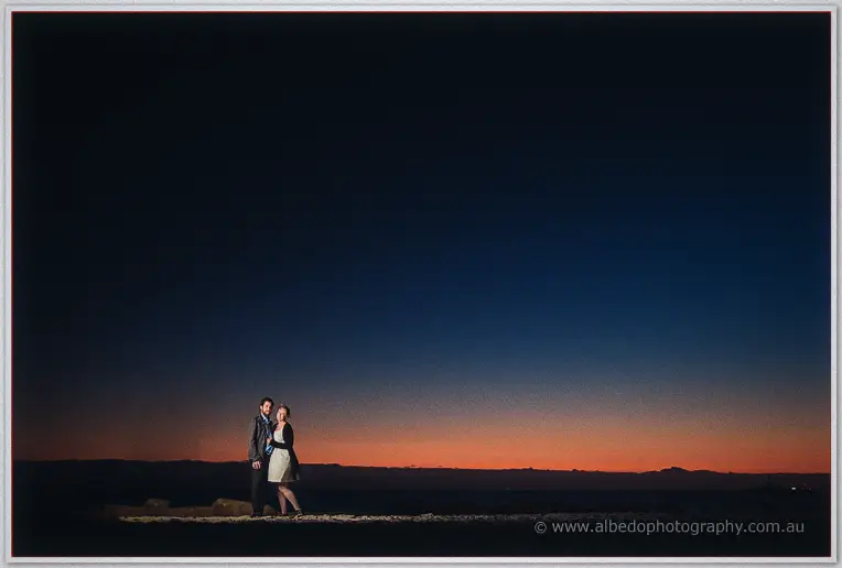 Alone on the darkened shore, Julie and Dale hold each other beneath a night sky