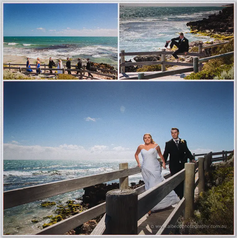Olivia and Max cross a coastal boardwalk above turquoise surf, Max hopping the railing nearby.
