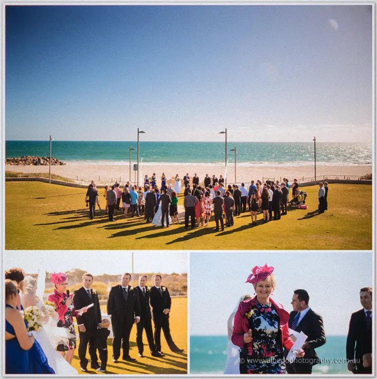 Olivia and Max line up with their bridal party on the oceanfront lawn, rings then exchanged by hand.