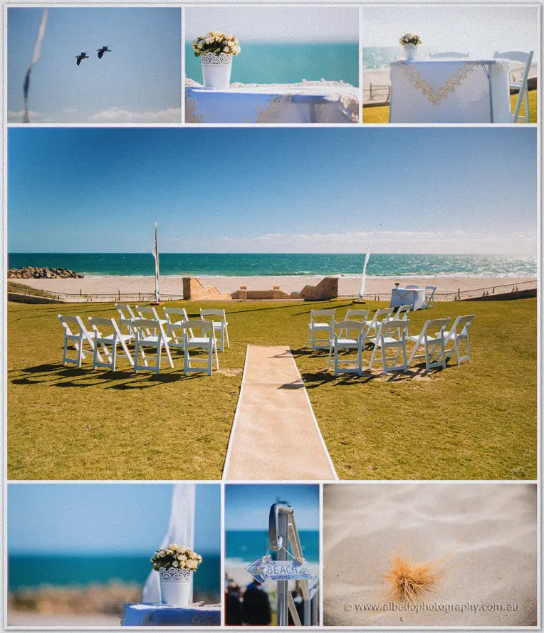 White folding chairs face the turquoise ocean across a sandy aisle under a bright blue sky.