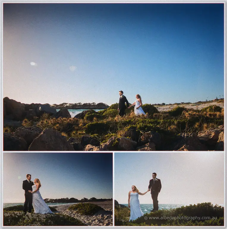 Olivia and Max walk hand in hand over golden dunes, then pause together along the coastal scrub.