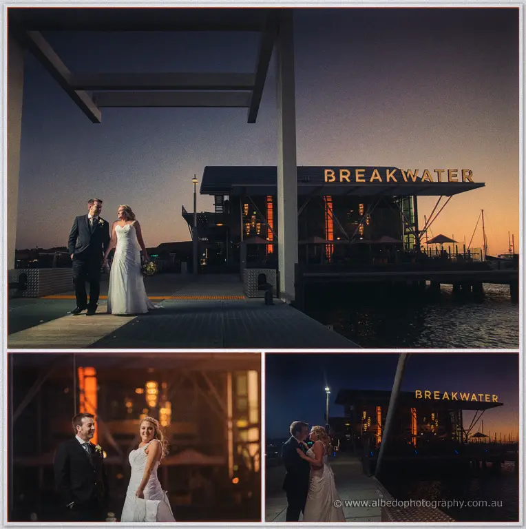 Olivia and Max laugh on the Breakwater jetty as its sign glows gold over the dusk water.