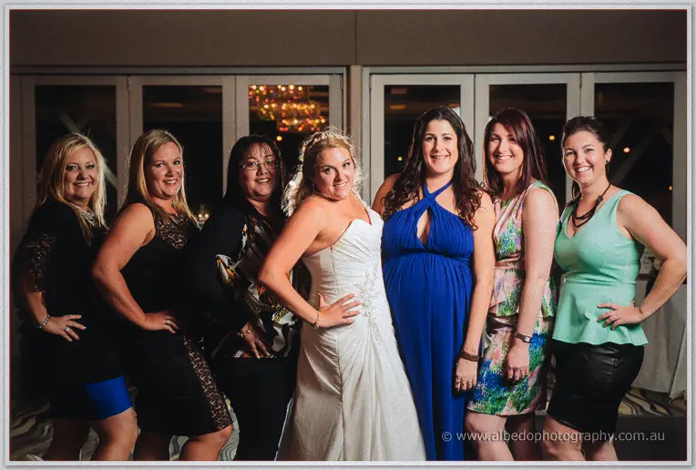 Olivia strikes a pose with six girlfriends in colourful dresses inside the evening reception room.