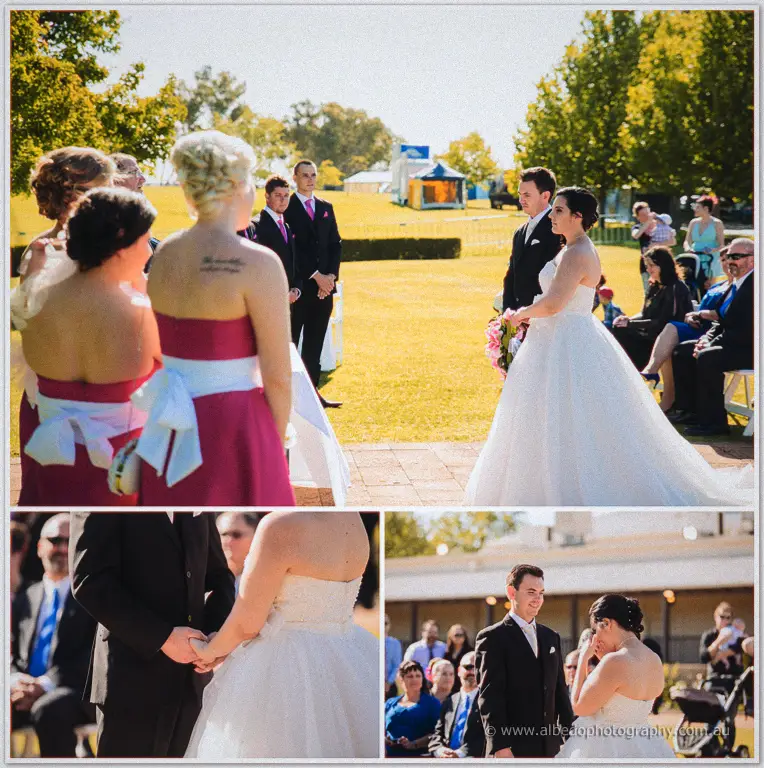 Sarah and Chris face each other during the ceremony holding hands as Sarah wipes away happy tears.