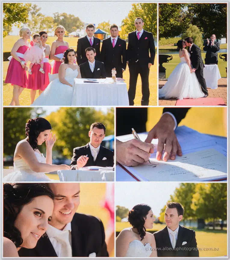 Sarah and Chris sign the marriage certificate surrounded by their smiling bridal party on the lawn.
