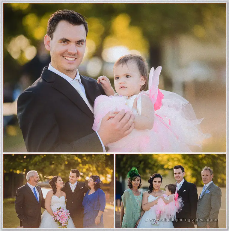 Chris cradles the flower girl in her pink fairy dress, with family group shots in golden afternoon light.