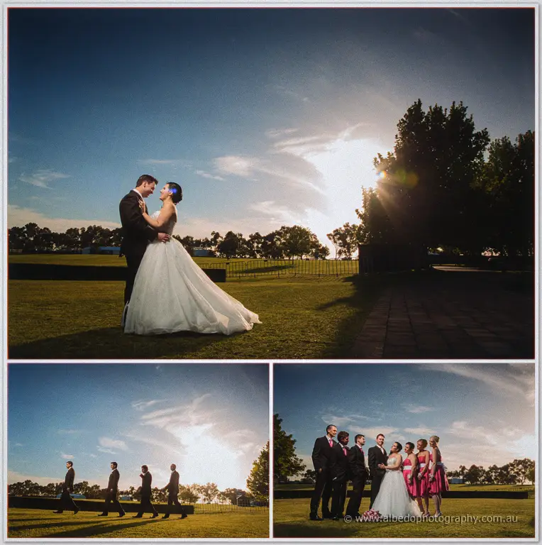 Sarah and Chris embrace in low sunset light on the lawns, with groomsmen walking the hedge line inset.