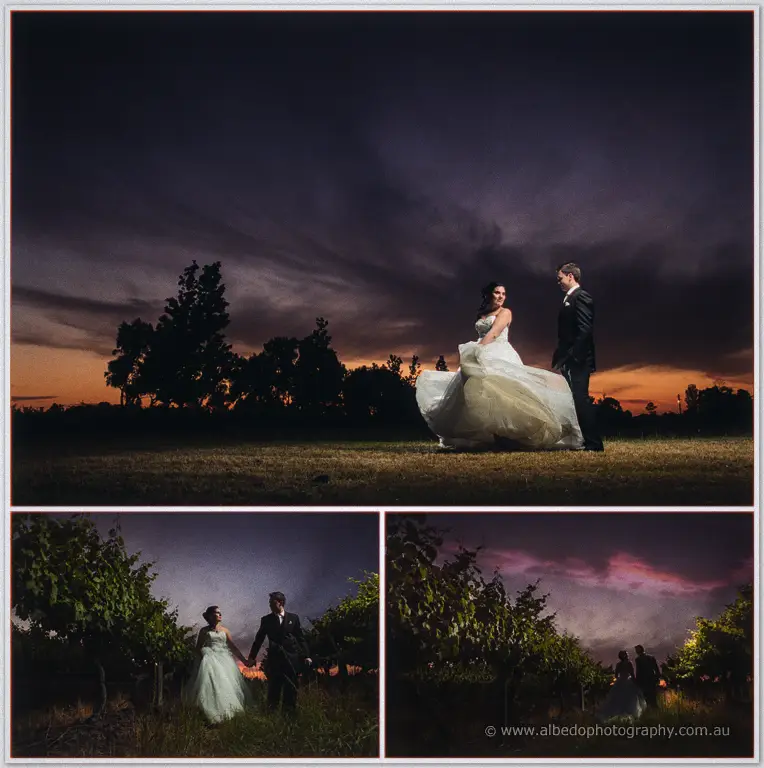 Chris lifts Sarah's gown hem as they stroll at sunset, then walk hand in hand through the vine rows.