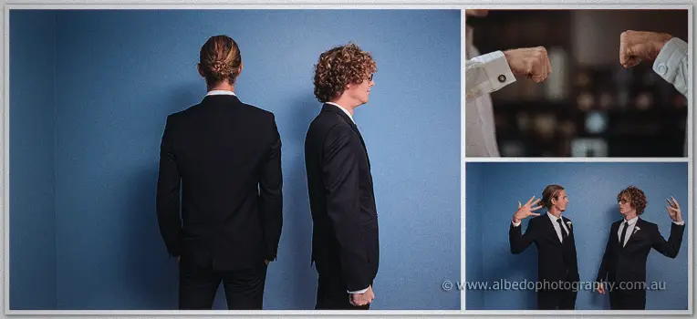Stephen and a groomsman pose back to back against a blue wall with a collage of cufflinks and peace signs