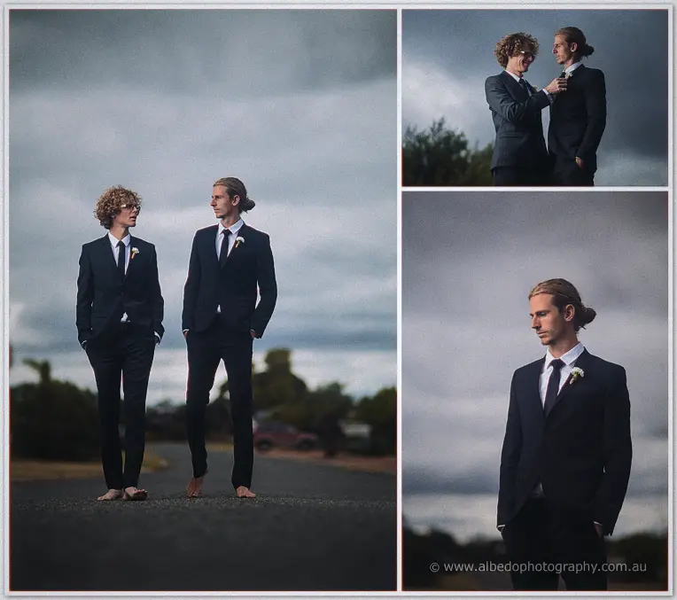 Stephen and his groomsman stand barefoot on a country road beneath brooding clouds in navy suits