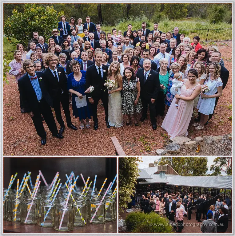 The whole wedding party assembles on the red gravel for a group portrait before the evening festivities