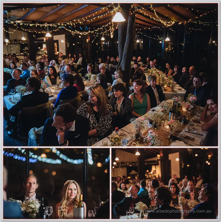 Guests lean in across candlelit tables as the father of the bride's speech gets underway