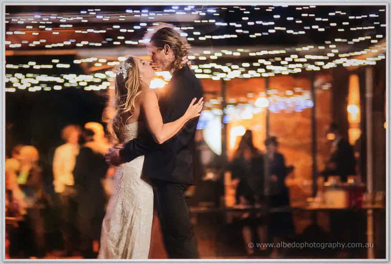 Tara and Stephen kiss mid-dance beneath a canopy of twinkling fairy lights