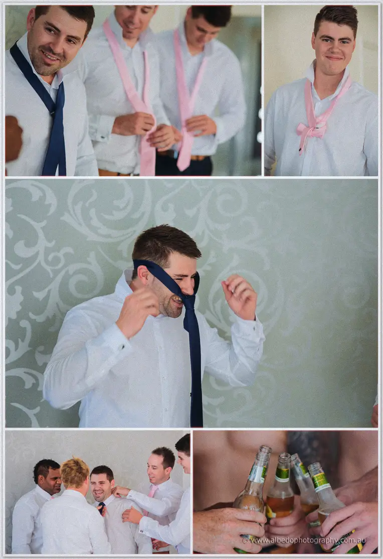 Groomsmen wrestle navy and pink ties into knots, laughing over bottles of beer as they get ready.