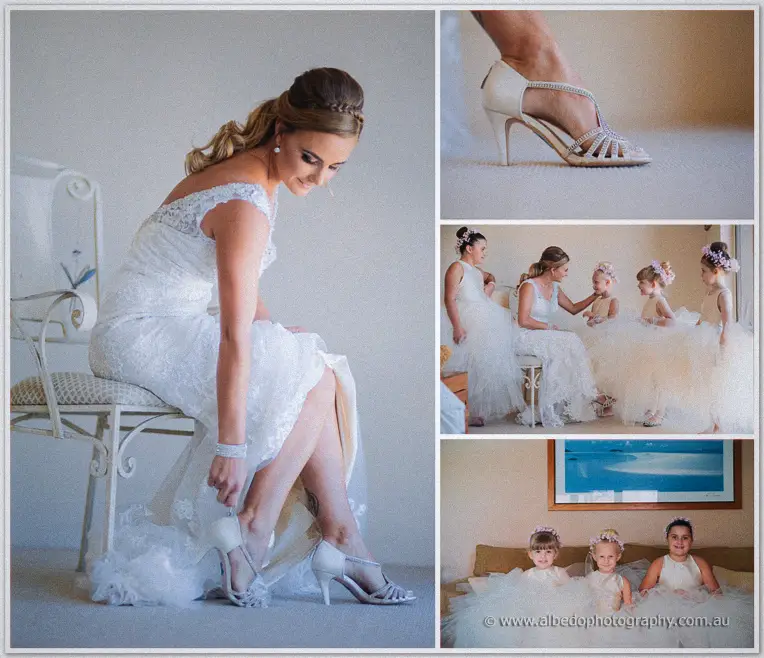Tarmecca buckles her silver heels beside flower girls in cloud-like tulle waiting on the bed.