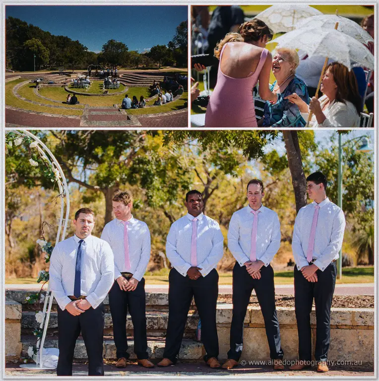Lee waits with groomsmen in pink ties beneath a flowered arch as guests fill the tiered Hillarys amphitheatre.