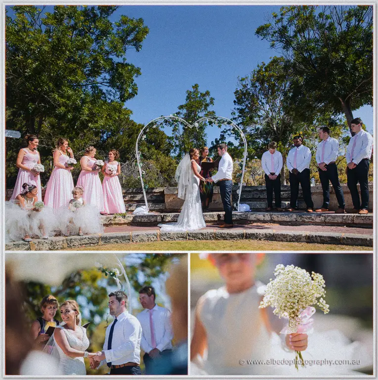 Tarmecca and Lee join hands beneath the heart-shaped arch as bridesmaids, groomsmen and guests look on.