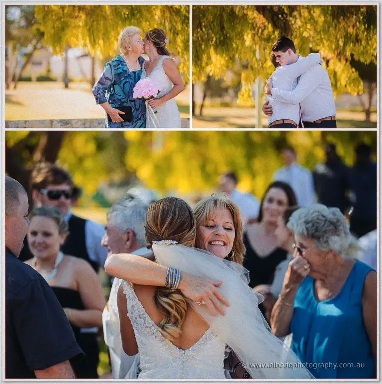 Tarmecca embraces smiling guests beneath golden willows after the ceremony, her veil catching the light