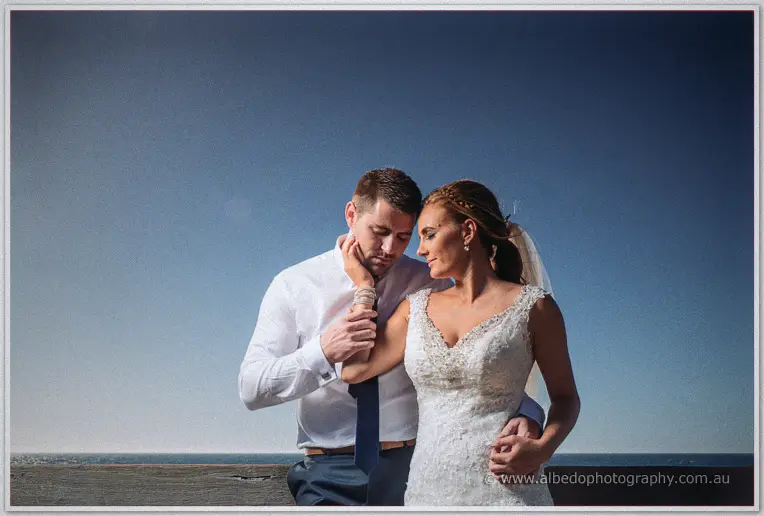 Lee presses his forehead to Tarmecca's as she cradles his face against a fading blue sky