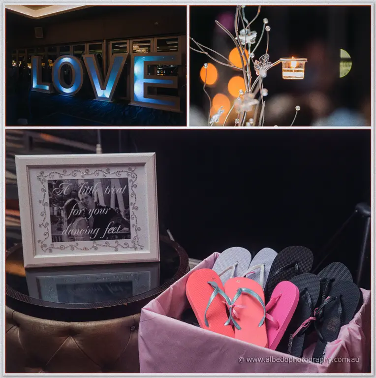 A lit LOVE sign and candelabra centrepiece frame a crate of thongs for guests' dancing feet