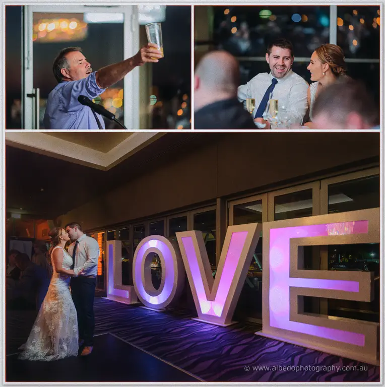 A groomsman raises his toast while Tarmecca and Lee laugh, then kiss beside giant LOVE letters