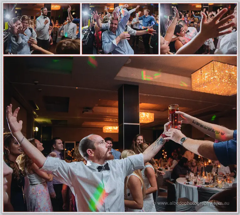 A bow-tied guest throws his arms up under disco lights as the crowd cheers around the dance floor